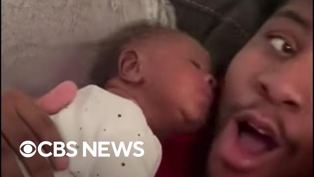 Newborn surprises dad with kiss Newborn surprises dad with kiss