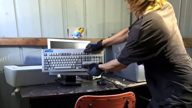 Angry office man destroys computer at new job Angry office man destroys computer at new job
