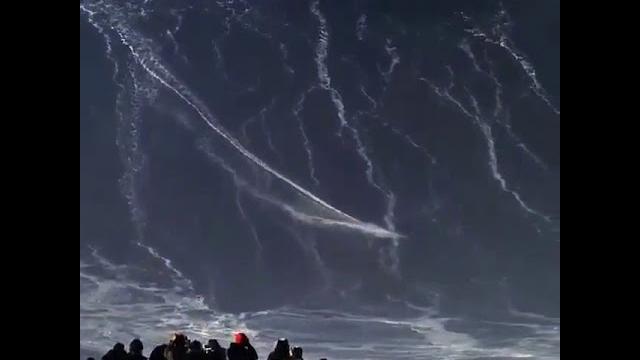 Guy surfing 100 foot tall wave Guy surfing 100 foot tall wave