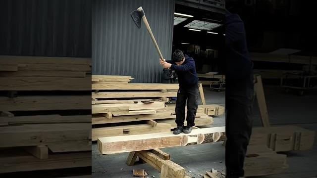 Splitting a tree with an axe while standing Splitting a tree with an axe while standing