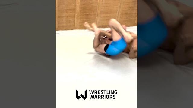 Teen judoka chokes opponent in a headscissor Teen judoka chokes opponent in a headscissor