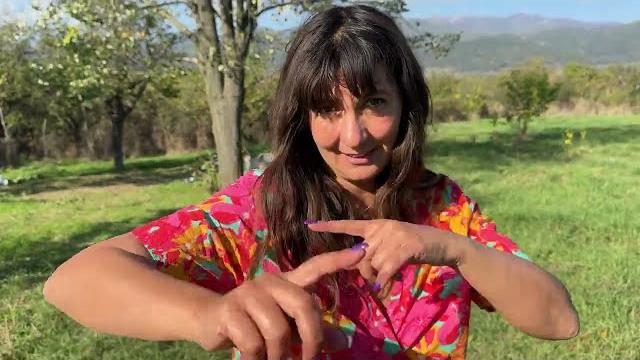 Tsetsi trimming branches in her yard and taking care of the garden of her bulgarian homestead Tsetsi trimming branches in her yard and taking care of the garden of her bulgarian homestead