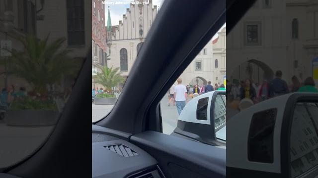 American tourists drive through pedestrian area in munich American tourists drive through pedestrian area in munich