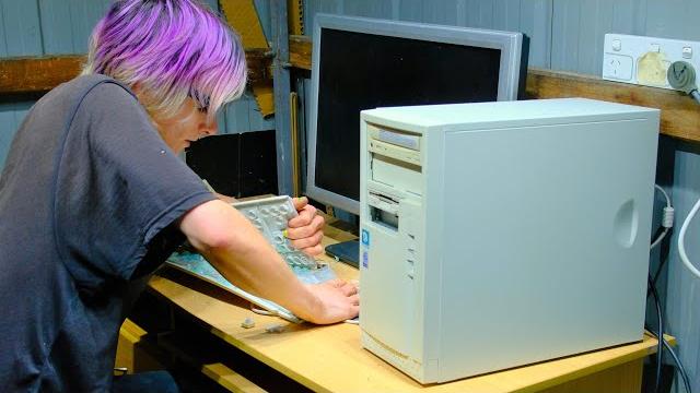 Angry office man destroys faulty vintage computer Angry office man destroys faulty vintage computer