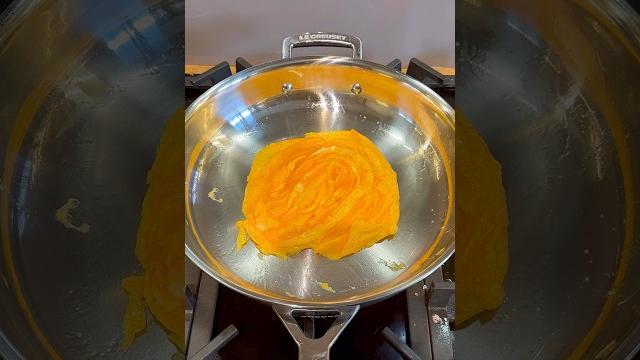 Folded egg in a stainless steel pan Folded egg in a stainless steel pan