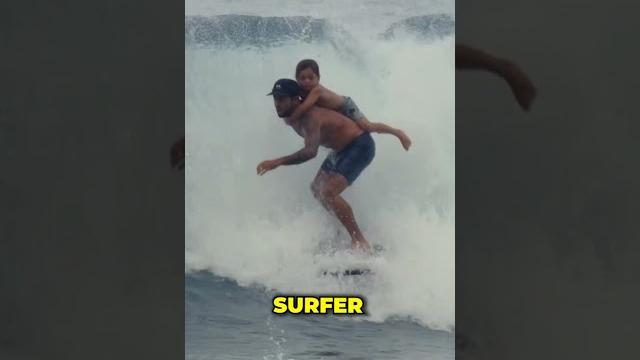 Surfing with his son on his back!️ Surfing with his son on his back!️