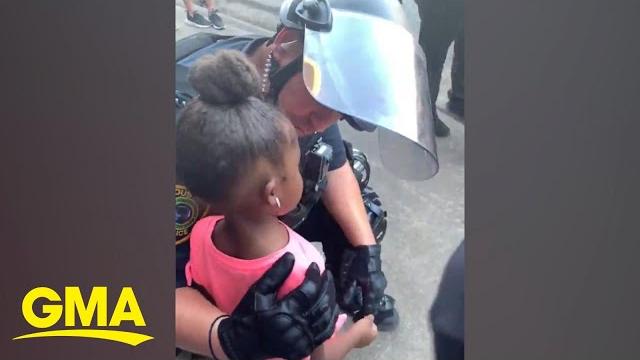 Police officer comforts little girl after she asks: 'are you going to shoot us?' l gma digital Police officer comforts little girl after she asks: 'are you going to shoot us?' l gma digital
