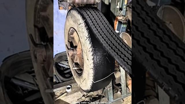 Tire retreading process: machine peeling off old tread from tire carcass for reapplication - tire Tire retreading process: machine peeling off old tread from tire carcass for reapplication - tire