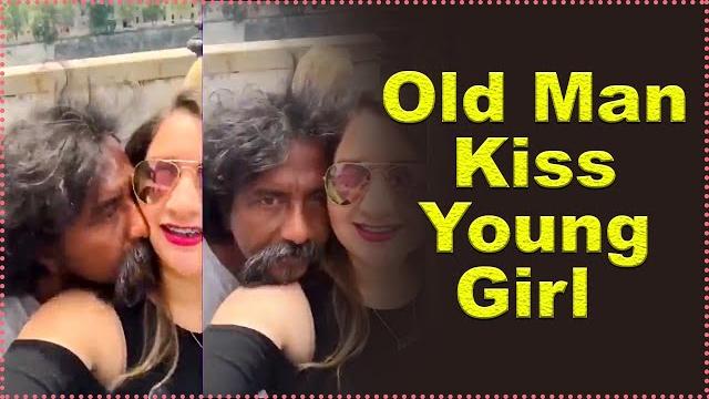 Old man kiss young girl in public place Old man kiss young girl in public place