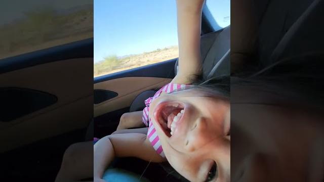 Little girl kissing her armpit. Little girl kissing her armpit.
