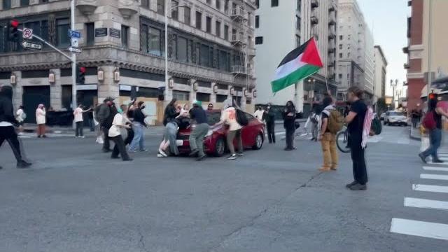 Ca: driver runs over protester in downtown la Ca: driver runs over protester in downtown la