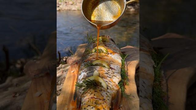 Cooking carp in primitive mud and leaves Cooking carp in primitive mud and leaves