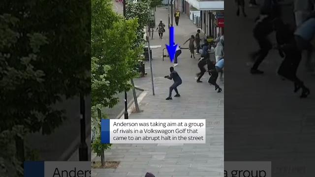 Moment man fires gun on busy street in north london Moment man fires gun on busy street in north london