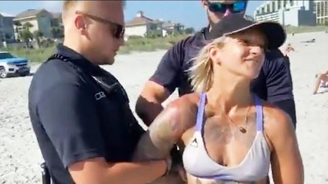 Cops dragged woman off beach after complaint about her bikini Cops dragged woman off beach after complaint about her bikini