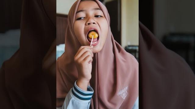 Hijab girl sucking lollypop Hijab girl sucking lollypop