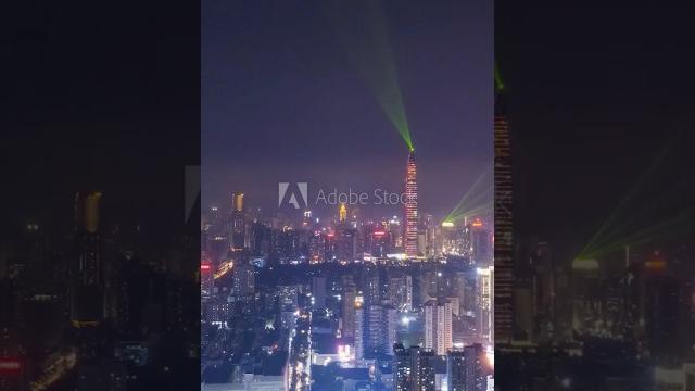 Shenzhen urban skyline at night. futian and luohu district. china. aerial view. drone flies backward Shenzhen urban skyline at night. futian and luohu district. china. aerial view. drone flies backward