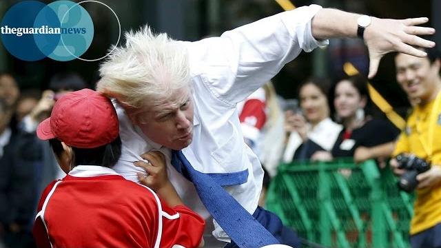 Boris johnson knocks over boy in rugby match in japan Boris johnson knocks over boy in rugby match in japan