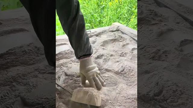 Iron shovel flipping bread in hot plant ash (sichuan, china) Iron shovel flipping bread in hot plant ash (sichuan, china)