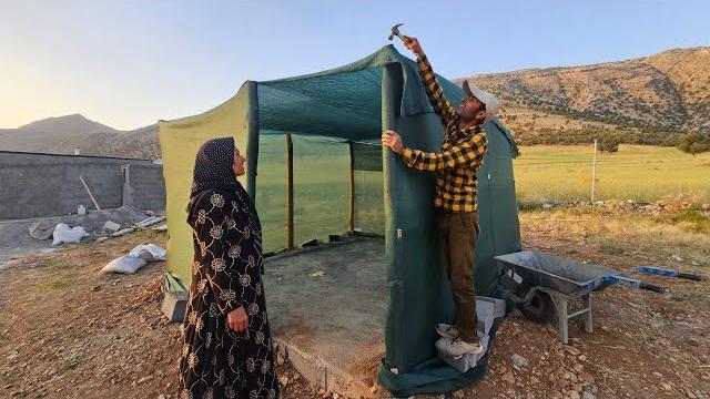 Sack shelter: a single mother uses only a sack to create a cool shelter from the summer heat Sack shelter: a single mother uses only a sack to create a cool shelter from the summer heat